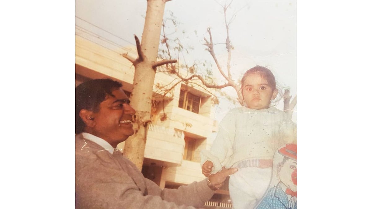 Authentic childhood photograph of toddler Virat Kohli supported by his smiling father Prem Kohli in Delhi, the foundational influence who took him to West Delhi Cricket Academy