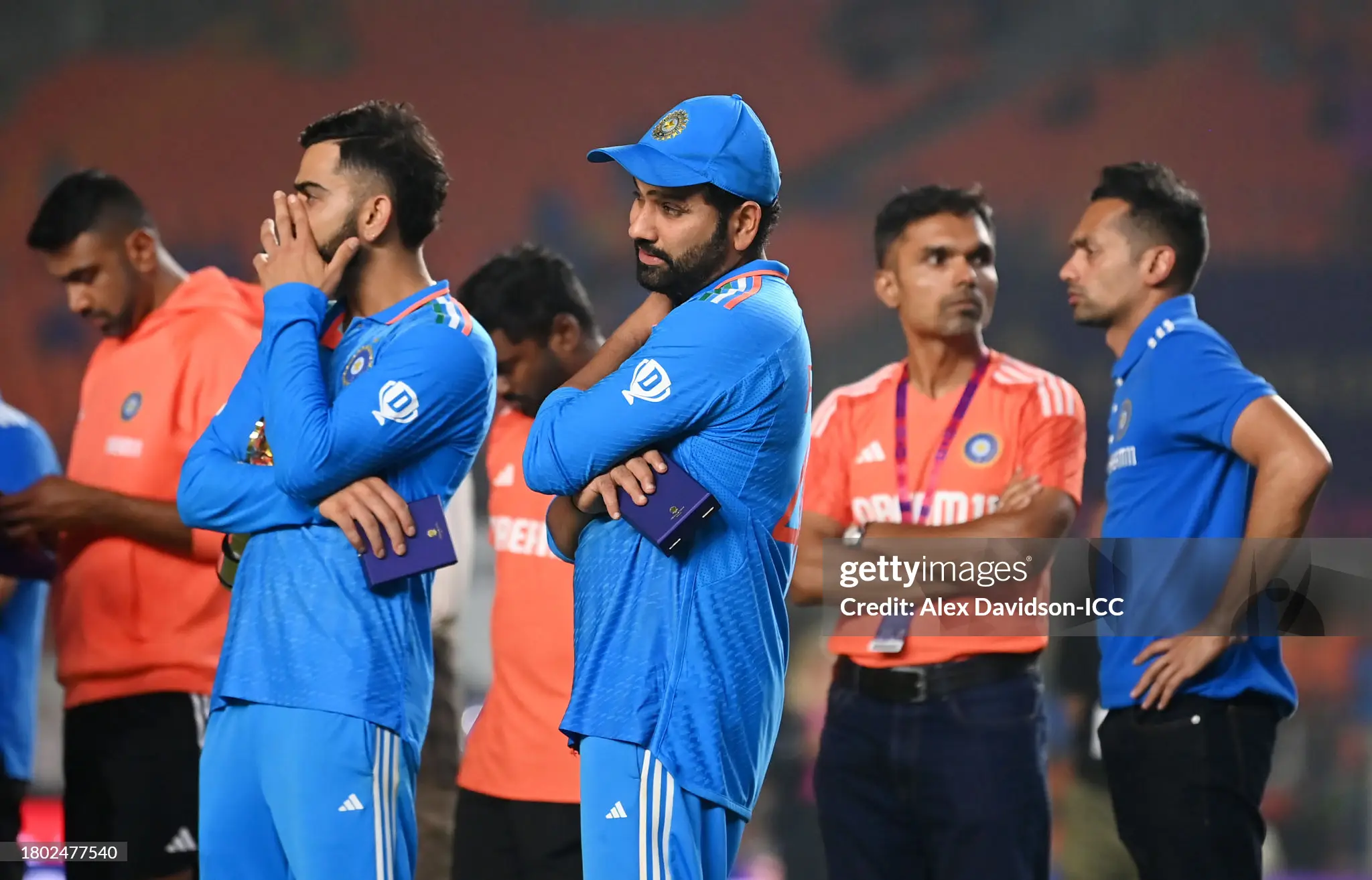 Virat Kohli with hand covering mouth standing alongside despondent Rohit Sharma after the 2023 World Cup Final in Ahmedabad